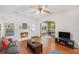 Cozy living room with fireplace, hardwood floors, and a seamless transition to the dining area at 2840 Smith Ridge Trce, Peachtree Corners, GA 30071