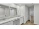 Bathroom featuring double vanity with granite countertops, framed mirrors, and tile flooring at 668 Egrets Landing #64, Covington, GA 30014