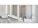 Modern bathroom featuring lighted mirrors, double sinks, and granite countertops at 668 Egrets Landing #64, Covington, GA 30014