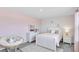 Charming bedroom with light pink walls, white furniture, and a cozy papasan chair at 668 Egrets Landing #64, Covington, GA 30014
