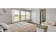 Inviting bedroom with large windows, light colored walls, and a papasan chair at 668 Egrets Landing #64, Covington, GA 30014