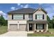 Charming two-story home featuring a two-car garage, black shutters, and manicured lawn at 668 Egrets Landing #64, Covington, GA 30014
