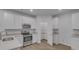 Bright kitchen featuring white cabinets, stainless steel appliances, and a walk-in pantry at 668 Egrets Landing #64, Covington, GA 30014
