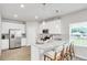 Modern kitchen featuring stainless steel appliances, a breakfast bar, and sleek white cabinetry at 668 Egrets Landing #64, Covington, GA 30014