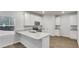 Modern kitchen with white cabinetry, stainless steel appliances, and granite countertops at 668 Egrets Landing #64, Covington, GA 30014