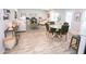 Open-concept living space with wood-look floors, a dining table and access to the backyard at 668 Egrets Landing #64, Covington, GA 30014
