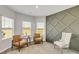 Inviting sitting room with stylish furnishings, a modern accent wall, and natural light from the windows at 668 Egrets Landing #64, Covington, GA 30014