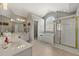 Bright bathroom featuring a soaking tub, glass shower, and a window for natural light at 1888 Fox Chapel Se Dr, Smyrna, GA 30080