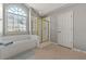 Bathroom boasting a soaking tub, a glass shower, and a large window at 1888 Fox Chapel Se Dr, Smyrna, GA 30080