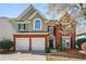 Charming two-story home with brick facade, well-manicured lawn, and a two-car garage at 1888 Fox Chapel Se Dr, Smyrna, GA 30080