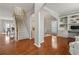 Open-concept living space with hardwood floors, staircase, and built-in shelving at 1888 Fox Chapel Se Dr, Smyrna, GA 30080