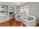 Bright office space with built-in shelving, hardwood floors, and comfortable seating at 1888 Fox Chapel Se Dr, Smyrna, GA 30080