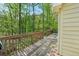 Wooden deck overlooking lush green trees surrounding the property at 230 Oakmere Dr, Alpharetta, GA 30009