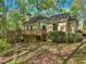 Exterior view of a house with a wooden deck, surrounded by greenery and mature trees at 230 Oakmere Dr, Alpharetta, GA 30009