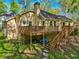 Outdoor living at its finest with a multi-level deck surrounded by verdant trees and landscaping at 230 Oakmere Dr, Alpharetta, GA 30009