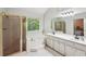Bathroom featuring shower, soaking tub, and double vanity with great natural light at 230 Oakmere Dr, Alpharetta, GA 30009