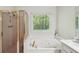 Bathroom showcasing a jacuzzi tub, with glass shower and vanity to the side at 230 Oakmere Dr, Alpharetta, GA 30009