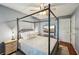 Cozy bedroom with neutral tones features a four poster bed and window seating at 230 Oakmere Dr, Alpharetta, GA 30009