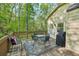 Cozy outdoor deck with seating and grill, perfect for entertaining in a wooded setting at 230 Oakmere Dr, Alpharetta, GA 30009
