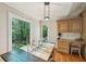 Bright dining area with large window, hardwood floors, and a view of the backyard at 230 Oakmere Dr, Alpharetta, GA 30009