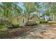 Single Gathering home showing attached garage and manicured landscaping at 230 Oakmere Dr, Alpharetta, GA 30009