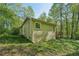 View of the home's exterior showing the siding and backyard with lush greenery at 230 Oakmere Dr, Alpharetta, GA 30009