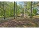A home nestled in the woods providing a peaceful, secluded setting at 230 Oakmere Dr, Alpharetta, GA 30009