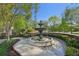 Picturesque tiered fountain surrounded by manicured landscaping in an outdoor setting at 230 Oakmere Dr, Alpharetta, GA 30009