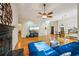 Spacious living room boasting hardwood floors, fireplace, and a ceiling fan at 230 Oakmere Dr, Alpharetta, GA 30009