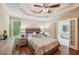 The spacious main bedroom has a tray ceiling, fan, and ensuite bathroom access at 230 Oakmere Dr, Alpharetta, GA 30009