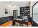A well-lit home office features a built-in bookshelf, hardwood floors, and a large window at 230 Oakmere Dr, Alpharetta, GA 30009