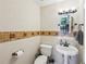 Stylish powder room with decorative tile and pedestal sink at 230 Oakmere Dr, Alpharetta, GA 30009