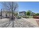 Outdoor dining area showcases open seating surrounded by manicured lawn, brick, and commercial architecture at 230 Oakmere Dr, Alpharetta, GA 30009
