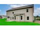 Rear exterior of a home with a spacious green lawn and neutral colored siding at 2336 Cadenza Cir, Dacula, GA 30019