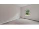 Neutral bedroom features fresh paint and carpet with a bright window overlooking the backyard at 2336 Cadenza Cir, Dacula, GA 30019