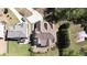 An aerial view of the property with a long driveway, pristine roof, and wooded area surrounding it at 5095 Hamby Hollow Ln, Cumming, GA 30028