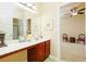 Bathroom featuring a vanity with dual sinks, decorative lighting, and ample counter space at 5095 Hamby Hollow Ln, Cumming, GA 30028