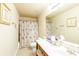 Bright bathroom features a vanity, toilet, framed mirror and floral shower curtain at 5095 Hamby Hollow Ln, Cumming, GA 30028
