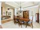 Formal dining room with elegant chandelier, hardwood table, and views into the adjacent living spaces at 5095 Hamby Hollow Ln, Cumming, GA 30028