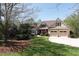 Charming two-story home featuring a stone facade, well-manicured lawn, and a two-car garage at 5095 Hamby Hollow Ln, Cumming, GA 30028