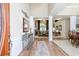 Elegant foyer with hardwood floors and decorative columns leading into the living spaces at 5095 Hamby Hollow Ln, Cumming, GA 30028