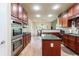 Spacious kitchen with granite counters, stainless appliances, wooden cabinets, and a center island at 5095 Hamby Hollow Ln, Cumming, GA 30028