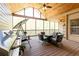 Relaxing screened porch with wood ceiling, ample seating, and an outdoor grill at 5095 Hamby Hollow Ln, Cumming, GA 30028