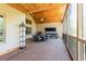 Large screened porch boasts a wood ceiling, comfortable seating, and an outdoor grill at 5095 Hamby Hollow Ln, Cumming, GA 30028