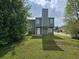View of backyard with trees and rear exterior view of home at 6718 Roscommon Dr, Austell, GA 30168