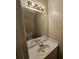 Cozy bathroom featuring a single sink vanity, large mirror, and vanity lighting at 6718 Roscommon Dr, Austell, GA 30168