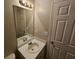 This is a bathroom with a white single sink vanity and a big mirror at 6718 Roscommon Dr, Austell, GA 30168