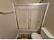 Bathroom featuring tub-shower combo with sliding door and toilet at 6718 Roscommon Dr, Austell, GA 30168
