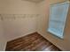 Walk in closet features shelving for storage, wood floors and natural light at 6718 Roscommon Dr, Austell, GA 30168