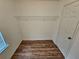 Spacious walk in closet offers a shelf for storage and wood floors at 6718 Roscommon Dr, Austell, GA 30168